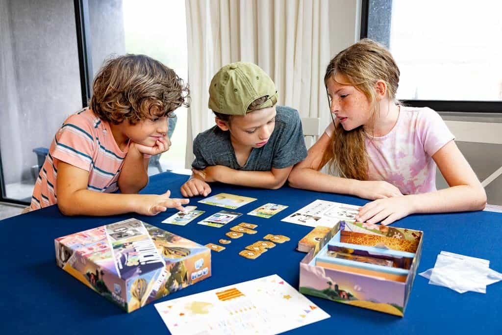 a group of kids playing a board game
